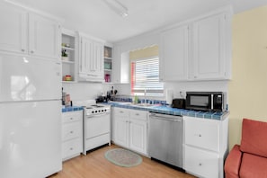 Kitchen with small stove, oven, and microwave