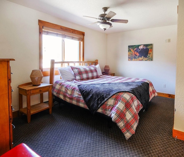 Relax in our stylish king bedroom featuring a luxurious king-sized bed and a sleek ensuite bathroom with a walk-in shower. Natural light fills the space, creating a serene and comfortable retreat.