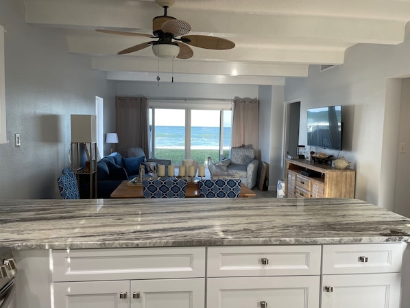 From the kitchen looking through the living room out to beach and ocean.