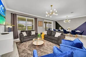 Our inviting living room features comfortable sofas, a large TV, and ample space for everyone to relax and get together