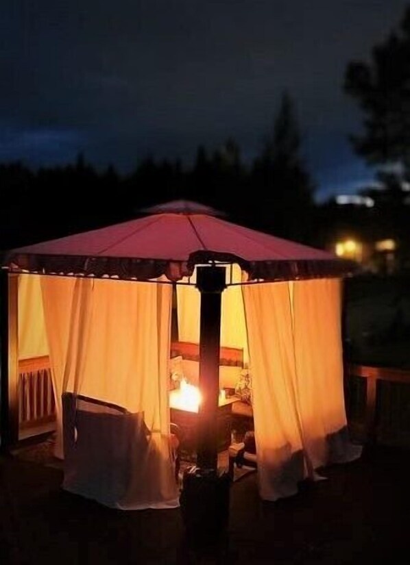 Nightime firepit glowing cabana