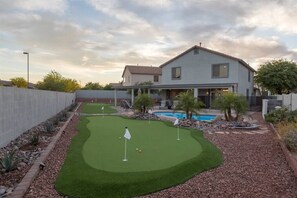 Enormous backyard w/ swimming pool heating optional, outdoor seating, fire pit, BBQ, and multiple putting greens