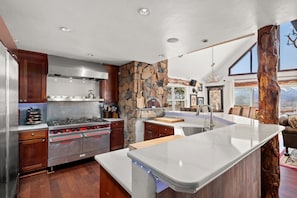 Your chef's kitchen with professional stove, large fridge, and spacious cookspace