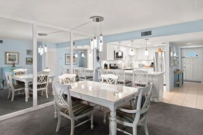 Dining table with seating for four and kitchen peninsula with seating for an additional three