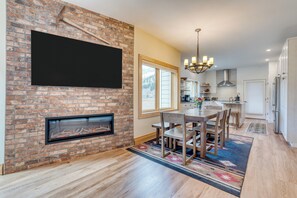 Cozy dining haven with TV and fireplace.
