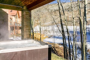 Hot tub with a mountain view.