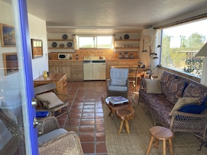 The living area and kitchen with table and chairs