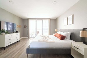 The sun-filled bedroom with a luxuriously large king bed