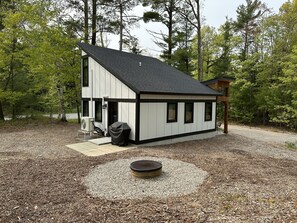 Back view of Ridge Way from the ridge showing the fire pit and back patio.