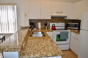 Equipped kitchen with granite counter tops