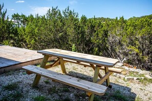 Enjoy a meal-or just good company-around the picnic table! A BIG bonus is that amazing elevated view of the Hill Country!