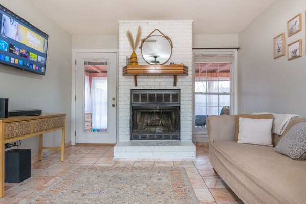 The living room features a fireplace and 50in smart tv