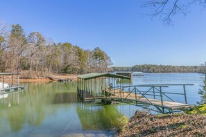 There are two docks that belong to the house. The one with the picnic table is uncovered  and the other is covered and is where the owners keep their pontoon. The covered dock has several boat ties (rope); you may tie up a rental boat, jet skis or any other watercraft on either side of that dock.