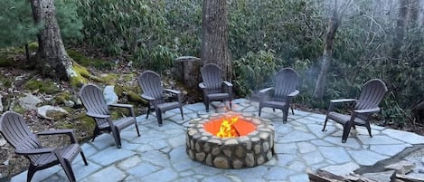 Gather around the outside firepit for cozy warmth and the enchanting ambiance of a winter escape.