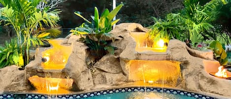 Lighted waterfall with fire feature gives a tropical oasis vibe!