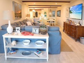 Designed for Comfort - Plush seating, a soothing color palette, a large, flat-screen TV, and a view of the ocean, the living area at Ponte Vedra Ocean Manor 106-D was furnished with comfort and relaxation in mind.