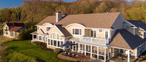 Sweeping views of the Lake Michigan shoreline await you in this luxuriously expansive vacation home.