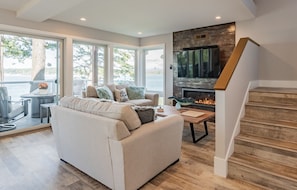 Clean, cozy living space with gas fireplace and smart TV.