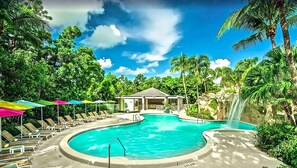 Outdoor swimming pool, poolside loungers and umbrellas