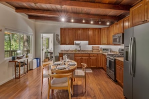 Open floorplan kitchen and dining area with door to the master suite.