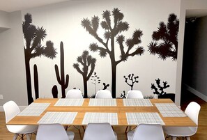 Bring the desert ambiance indoors. Enjoy dining under the silhouette of desert cacti and Joshua trees. .