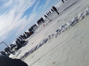 Ice fishing and snow mobile riding on the lake