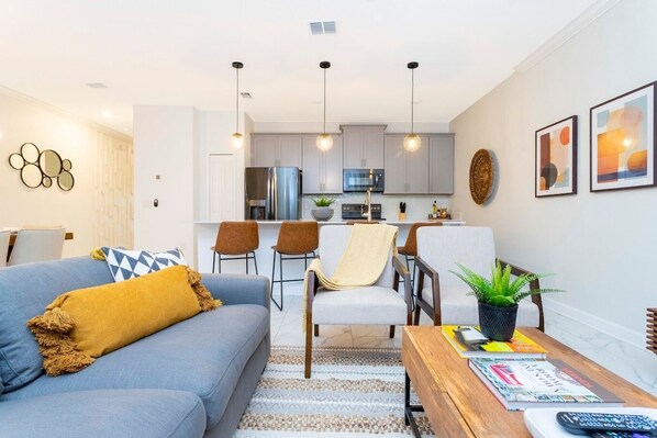  Enjoy the smart TV, ceiling fan, and open floor concept, creating a bright and inviting atmosphere.