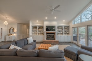 Custom, built-in shelving surround the fireplace and provide a modern, yet cozy touch in the center of the home