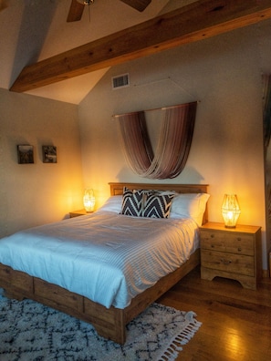 The cozy primary bedroom suite offers amazing views from the comfort of your bed