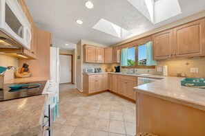 All our rental homes feature fully stocked kitchens. This kitchen has granite countertops with top quality appliances.