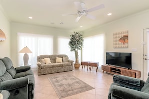 Downstairs has a second living room with easy pool and yard access.