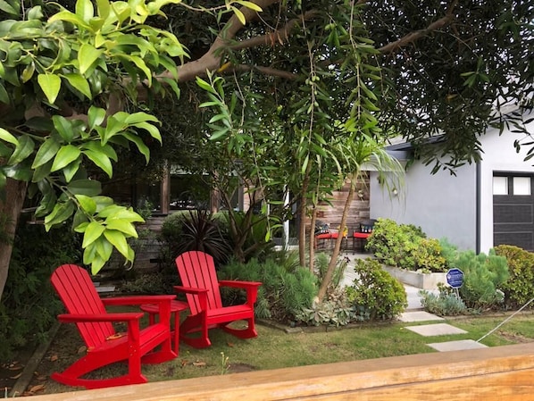 Bright red adirondack chairs in the front yard 