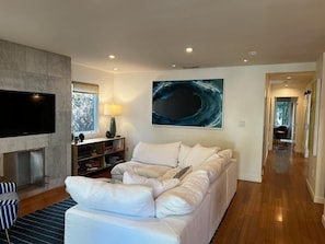 Comfy cloud sofa in bright living room with magnificent painting of a wave