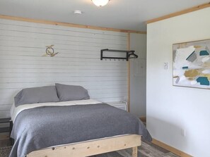 An inviting queen bed in the newly renovated Aurora cabin