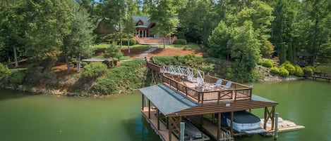 private dock, wooded lot with open grassy areas too. Boat not included.