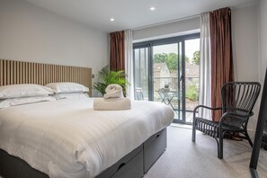 Bedroom One with sliding doors leading out onto the balcony