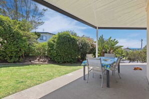 Covered outdoor dining area with gas bbq