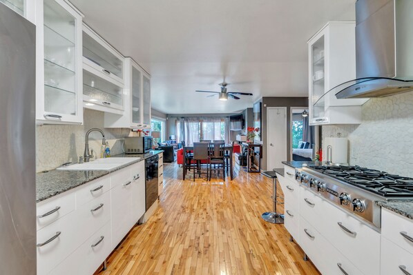 Main level kitchen with dishwasher, oven, stove top, full sized refrigerator.  Fully equipped with pots, pans, dishes, silverware, coffee maker, toaster, blender, mixer, kitchen gadgets, everything you will need.