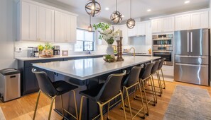 Upscale kitchen with Bosch appliances and quartz countertops