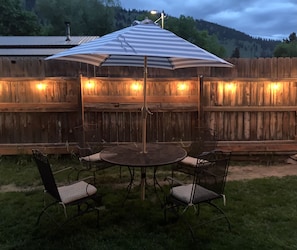 Edison lights surround the back deck and patio area for evening ambiance.