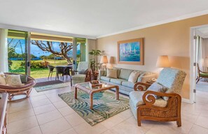 This spacious living area opens up to a private patio with ocean views. The perfect setting for relaxation and enjoying Maui's stunning scenery.