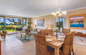 An open and airy living space with tropical decor, ocean views, and a seamless indoor-outdoor flow, perfect for island relaxation.