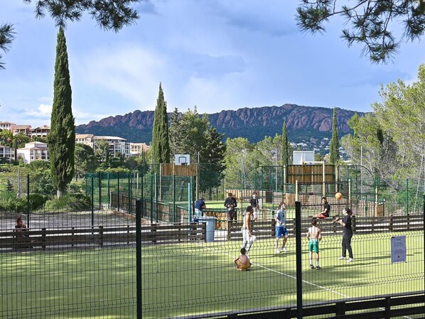 Sky, Plant, Cloud, Tree, Fence, Building, Grass, Mesh, Public Space, Mountain