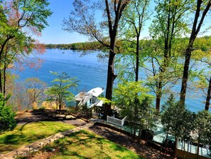 Embrace the charm of a steep, multi-level yard with a series of steps leading to the tranquil lake.