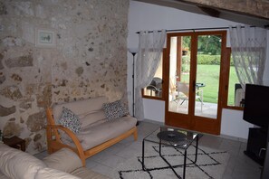 Lovely bright sitting room with view to garden, leading onto terrace