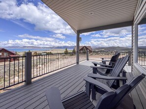 Spacious deck with Adirondack chairs, stunning lake views, and breathtaking mountain scenery.