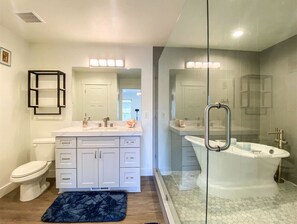 Elegant spa-like bathroom with soaking tub, glass shower, and modern touches for total relaxation.