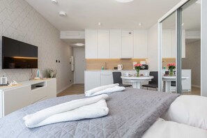 A cozy space featuring a sofa, television, and decor, designed for entertainment and relaxation.