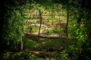 Berm is DIRECTLY at the trailhead of the famous mountain biking trail, Slaughter Pen Trail.