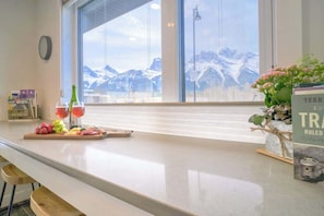 Breakfast bar and working station in Kitchen. Taking in the Mountain views and train watching